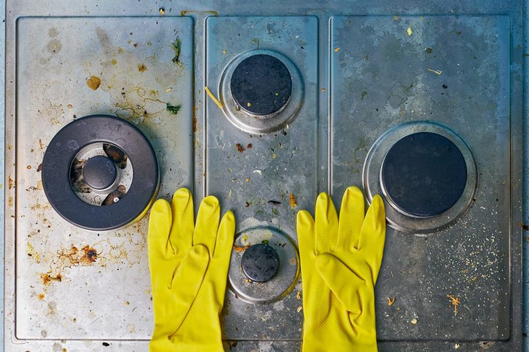 gloves on dirty stove top