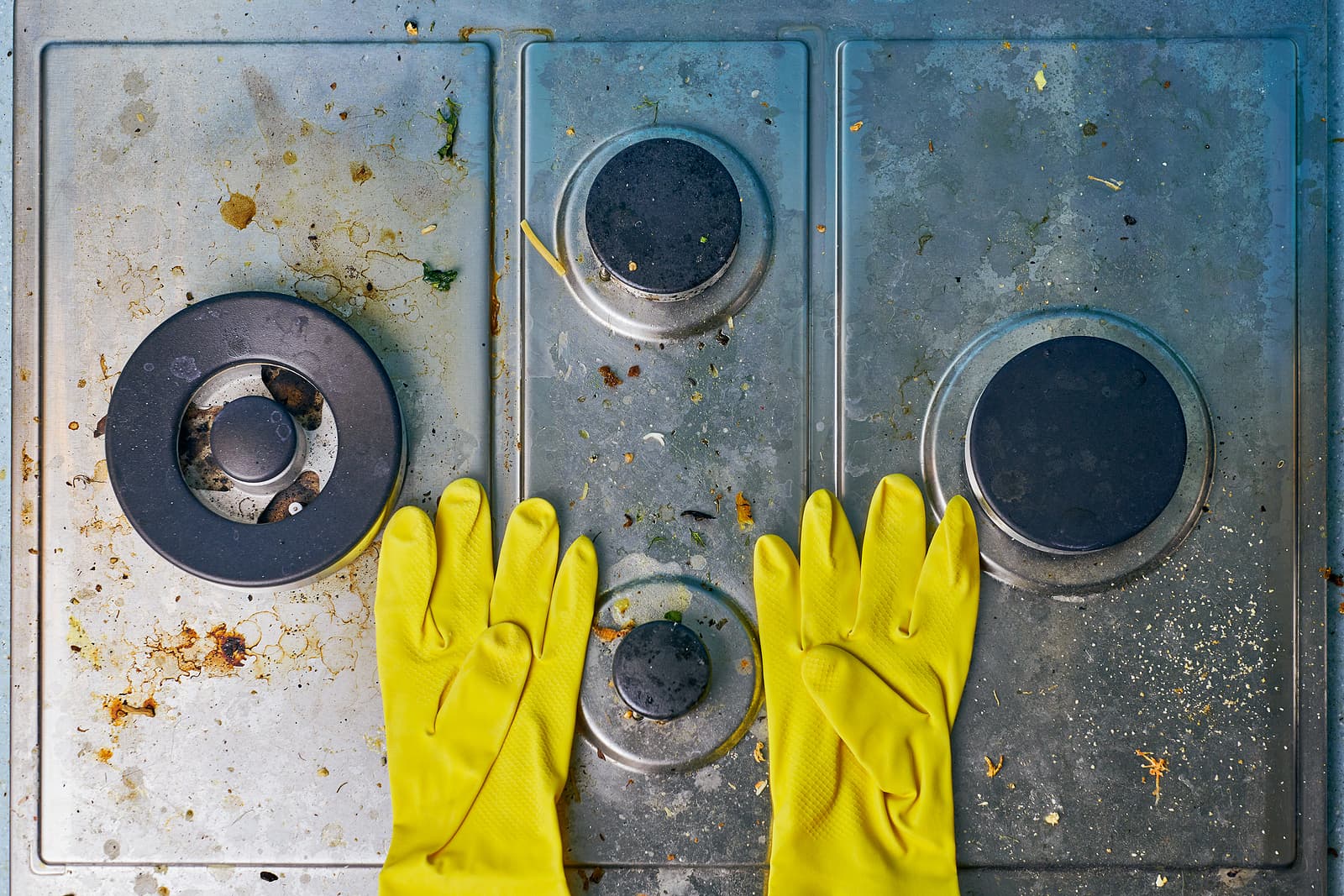gloves on dirty stove top